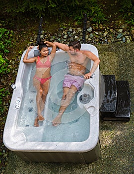 couple in hot tub bath in the rain forest of Vancouver Island, men and women in jacuzzi