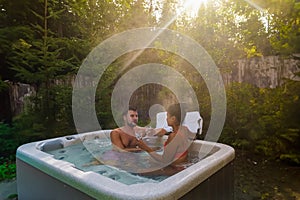 couple in hot tub bath in the rain forest of Vancouver Island, men and women in jacuzzi