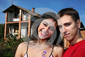 couple beside house