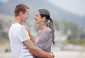 Couple, hug and beach for travel, happiness together and fresh air outdoor. Romantic adventure, love and affection for
