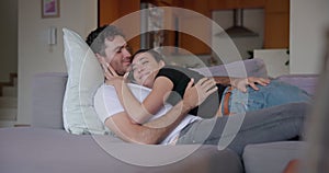 Couple, hug and lying on sofa for love, care and relax together with trust, comfort and support at home. Happy man