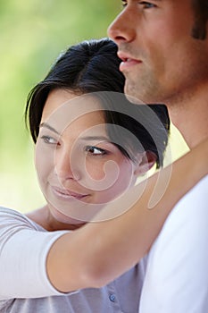 Couple, hug and outdoors together for bonding, love and affection in marriage or romance in nature. People, happy and