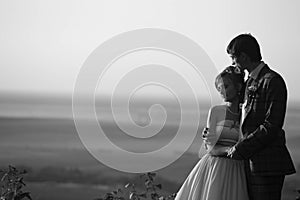 Couple is hugging on the background horizone