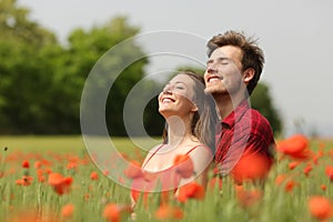 Couple hugging and breathing fresh air in a red field