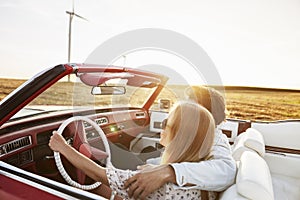 Couple hugging in the car during sunset