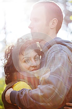 Couple hugging each other in sunlight