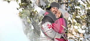 Couple hugging each other in winter forest