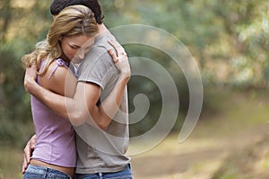 Couple Hugging In Forest