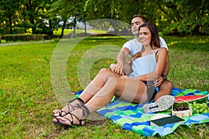 Couple hugging and having picnic in park