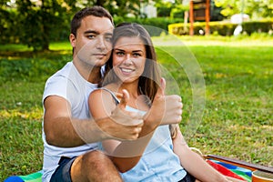 Couple hugging and having picnic in park