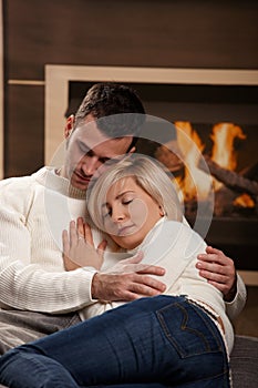 Couple hugging home