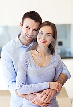 Couple hugging at home