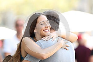 Couple hugging on the street after encounter