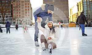 couple ice skating outdoors on a winter day