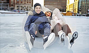 couple ice skating outdoors on a winter day