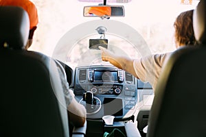 Couple inside car uses GPS navigator