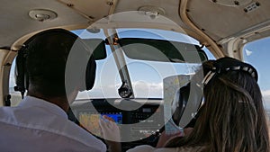 A couple inside the cockpit of an small airplane