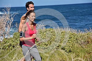 Couple of joggers by the seaside