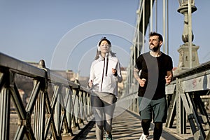 Couple jogging on Chain Bridge in Budapest