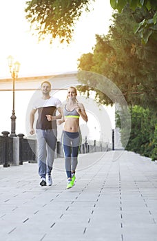 Couple jogging outside, runners training outdoors working out in