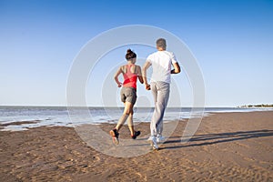 Couple jogging outside, runners training outdoors working out
