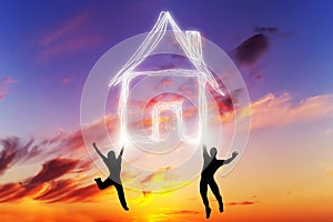 A couple jump and make a house symbol of light