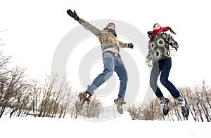 Couple jumping in snow