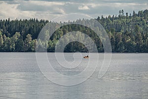 couple Kayaking Boat tour on lake Ragnerudssjoen in Dalsland Sweden beautiful nature forest pinetree