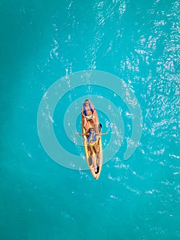 Couple Kayaking in the Ocean on Vacation Aruba Caribbean sea, man and woman mid age kayak in ocean blue clrea water