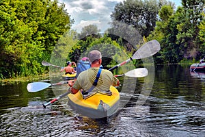 Couple kayaking together in river. Tourists kayakers touring the river