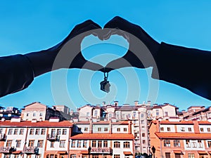 Couple keeps keys new housing. hands silhouette holding house keys house shaped keychain. Male and female hands