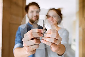 Couple with a key moving into their new house.