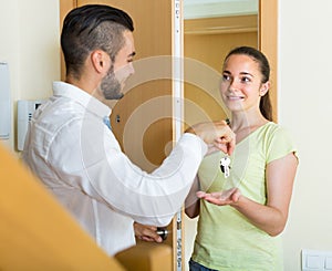 Couple with keys at the door