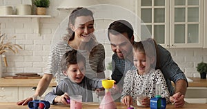 Couple and kids playing with chemistry science hands-on kit