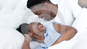 Couple kiss, funny conversation and bed communication in the morning, relax in bedroom and happy together in marriage at