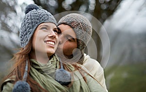 Couple, kiss and happy outdoor with travel for bonding, love and relationship with winter or holiday. Man, woman and