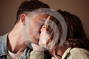 Couple kiss, love or gay men for trust, romance or support in studio with brown background. Happy, relax or LGBT people