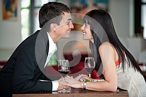 Couple Kiss Over Meal