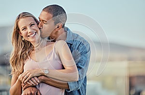 Couple, kiss and smile of people with a hug together outdoor feeling love, care and happiness. Portrait of marriage