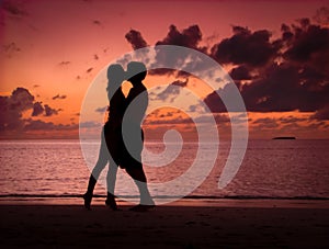 Couple Kissing on a Beach at Sunset