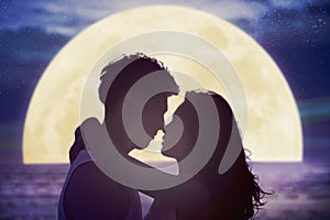 couple kissing on beach and watching the moon.Celebrate Mid autumn festival