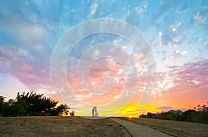 Couple kissing during a colorful sunset