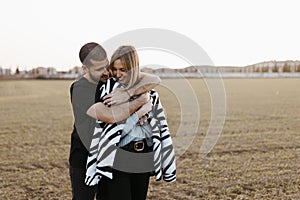 Couple kissing in the countryside embraced. Boyfriend and girlfriend in love