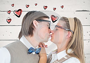 Couple kissing each other against heart graphics