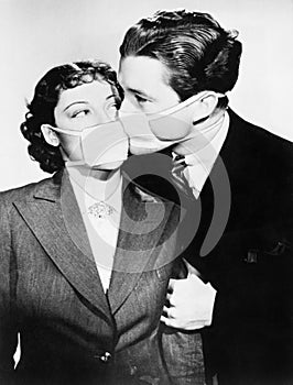 Couple kissing each other with health masks