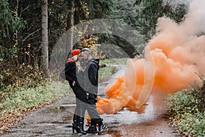 couple kissing in the fog. lovers tenderness colored smoke steam white on the path forest romance stylish passionate