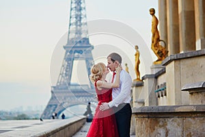 Couple kissing in front of the Eiffel tower in Paris, France