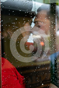 couple kissing and holding each other passionately in phone box