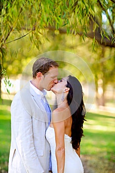 Couple kissing in honeymoon outdoor park