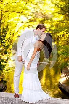 Couple kissing in honeymoon outdoor park